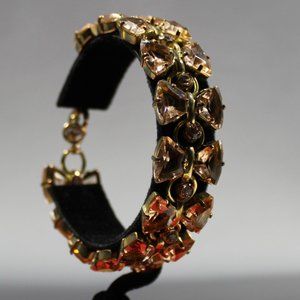 Sorrelli bracelet, gold tones with two rows of peach colored rhinestones